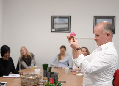demonstrating how to make a buttonhole Learning the Art of Floristry